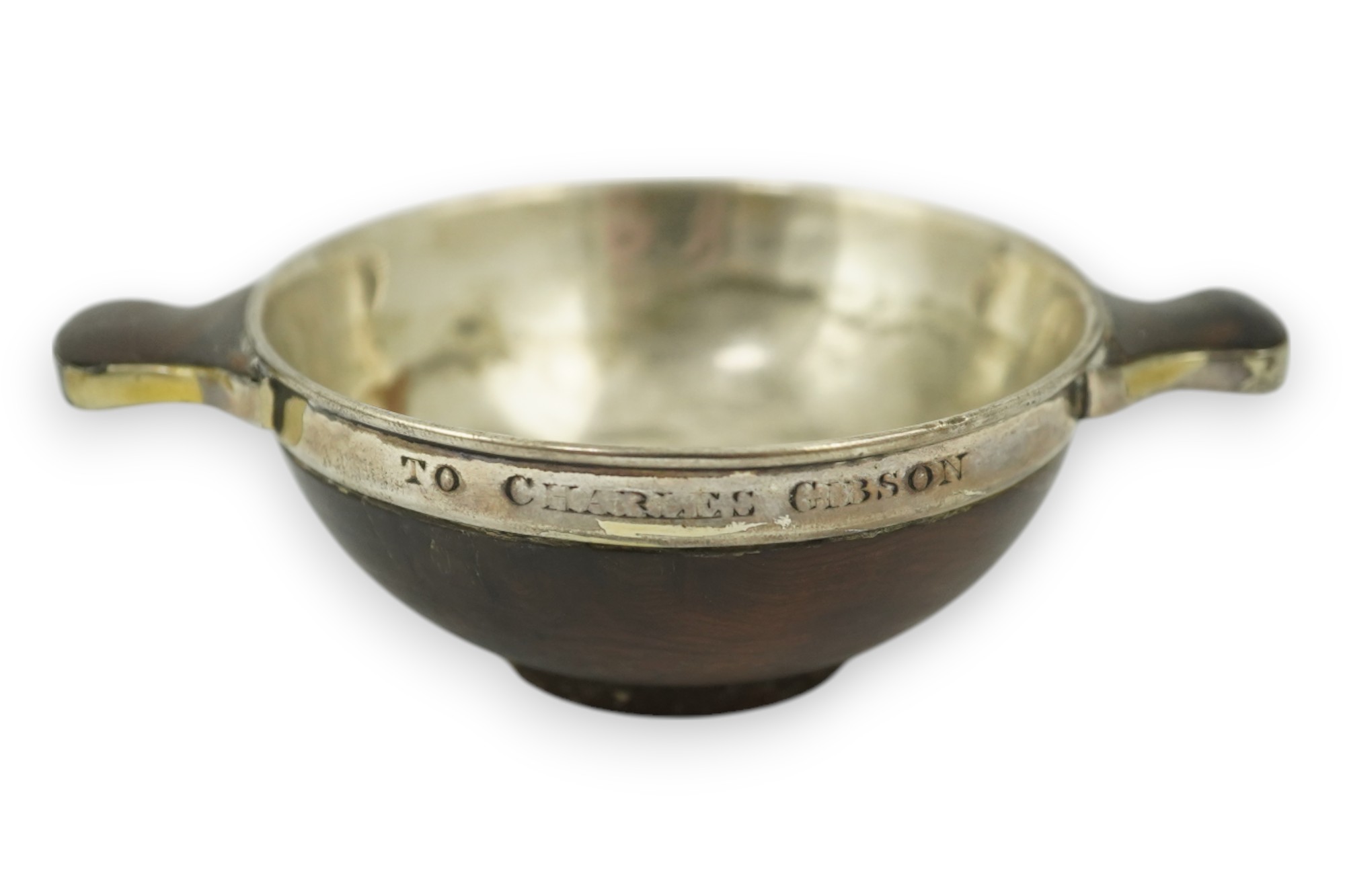 An early 19th century silver mounted yew wood quaich, inscribed 'Scuab As E' to the bowl and 'To Charles Gibson / From A Butter of Faskally' around the rim, dated 1830 beneath one handle, 10.6cm over handles. Condition -